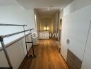 Bedroom with wooden flooring and storage