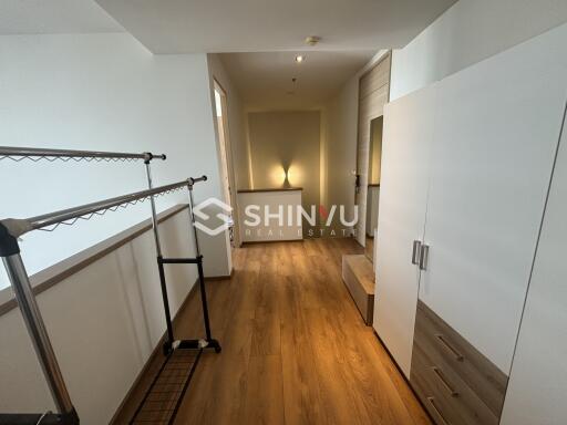 Bedroom with wooden flooring and storage