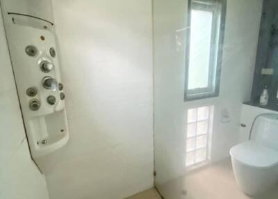 Modern bathroom with glass shower door and advanced shower panel