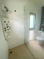 Modern bathroom with glass shower door and advanced shower panel