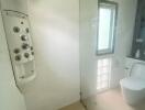 Modern bathroom with glass shower door and advanced shower panel