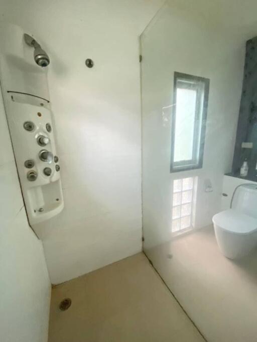 Modern bathroom with glass shower door and advanced shower panel