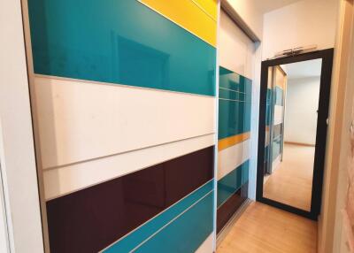 Hallway with colorful sliding doors and a mirror