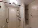 Shower area with glass door and shelves