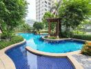 Swimming pool surrounded by greenery and buildings