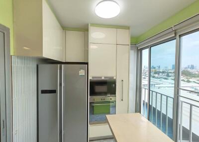 Modern kitchen with large refrigerator and built-in oven