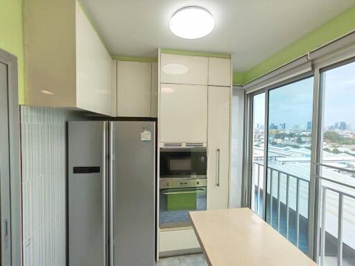 Modern kitchen with large refrigerator and built-in oven