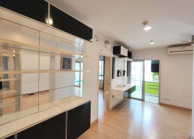 Bright and modern living area with built-in shelving and adjacent balcony