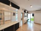 Bright and modern living area with built-in shelving and adjacent balcony