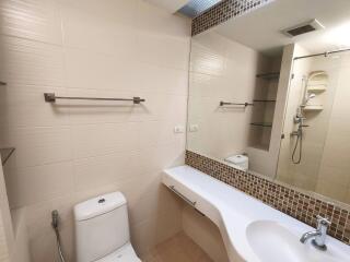 Modern bathroom with large mirror and wall-mounted fixtures