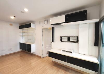 Modern living room with wooden flooring and built-in storage