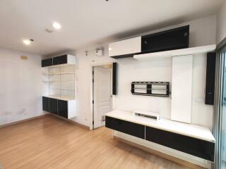 Modern living room with wooden flooring and built-in storage