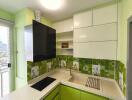 Modern kitchen with green and white cabinetry and tile backsplash