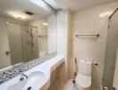 Modern bathroom with a large mirror and shower