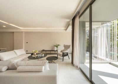 Modern living room with large windows and white furniture