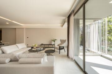 Modern living room with large windows and white furniture