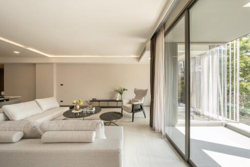 Modern living room with large windows and white furniture