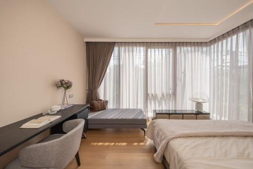 Bright and cozy bedroom with a study desk and large windows