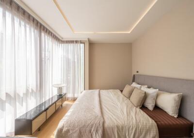 Modern bedroom with large windows and natural light