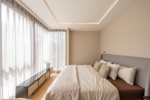 Modern bedroom with large windows and natural light