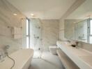 Modern bathroom with freestanding bathtub, walk-in shower, and large vanity mirror