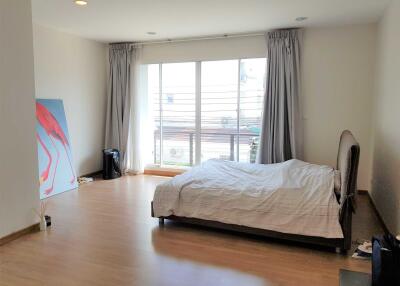 Bedroom with large window and bed