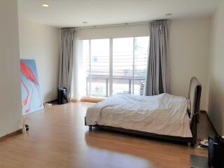 Bedroom with large window and bed