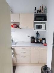 Compact kitchen with appliances and cabinets