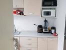 Compact kitchen with appliances and cabinets