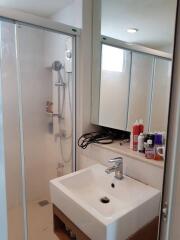 Modern bathroom with shower, sink, and mirror