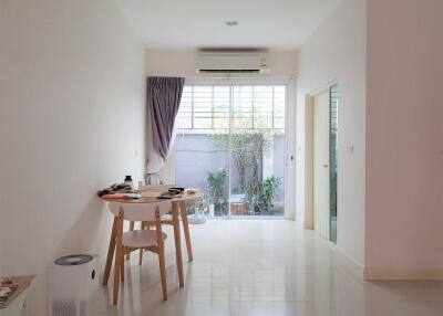 Modern living room with dining table and glass doors