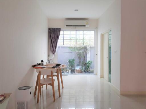 Modern living room with dining table and glass doors