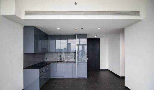 Modern kitchen with dark cabinets and high ceilings