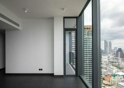 Empty room with large floor-to-ceiling windows and city view