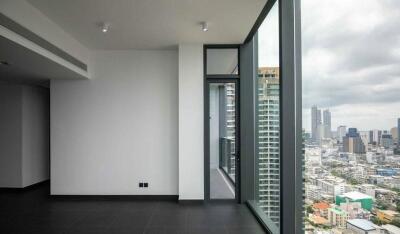 Empty room with large floor-to-ceiling windows and city view