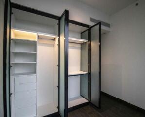 Spacious bedroom closet with shelving and storage