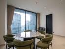 Modern dining area with round table and green chairs