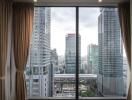 City view from a high-rise window with curtains