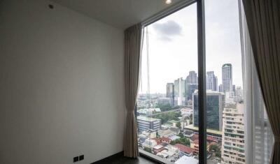 Bedroom with large glass window and city view