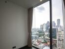 Bedroom with large glass window and city view