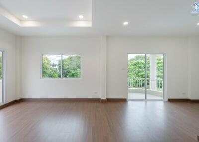 Spacious living room with large windows and balcony access