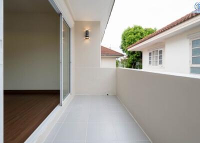 Outdoor balcony area with a view of adjacent building