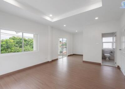 Spacious and well-lit main living space with large windows and access to a balcony.