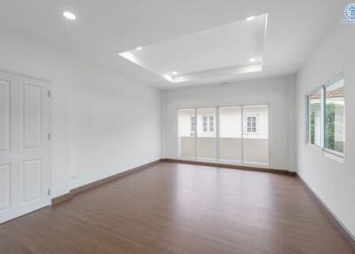 spacious living room with wooden flooring and large windows