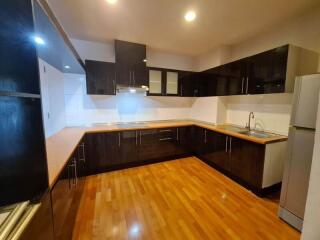 Modern kitchen with wooden flooring and black cabinetry