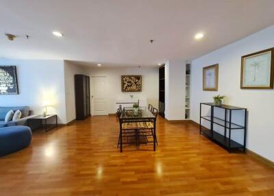 Spacious living area with dining table and wooden flooring