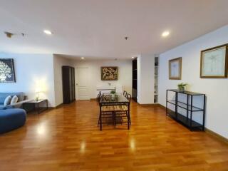 Spacious living area with dining table and wooden flooring