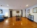 Spacious living area with dining table and wooden flooring