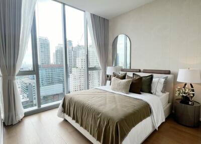 Modern bedroom with large windows and city view