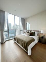 Modern bedroom with large windows and city view